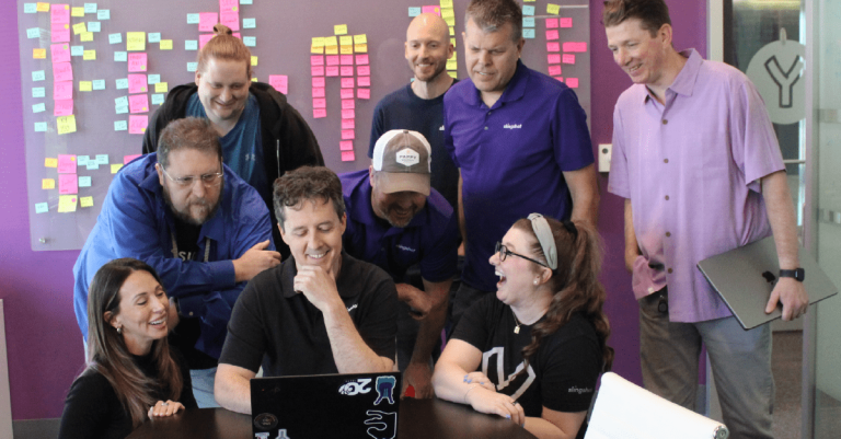 The Next 20 Years - David's Final Thoughts on 20 Moments/20 Years - David and team laughing around a computer screen